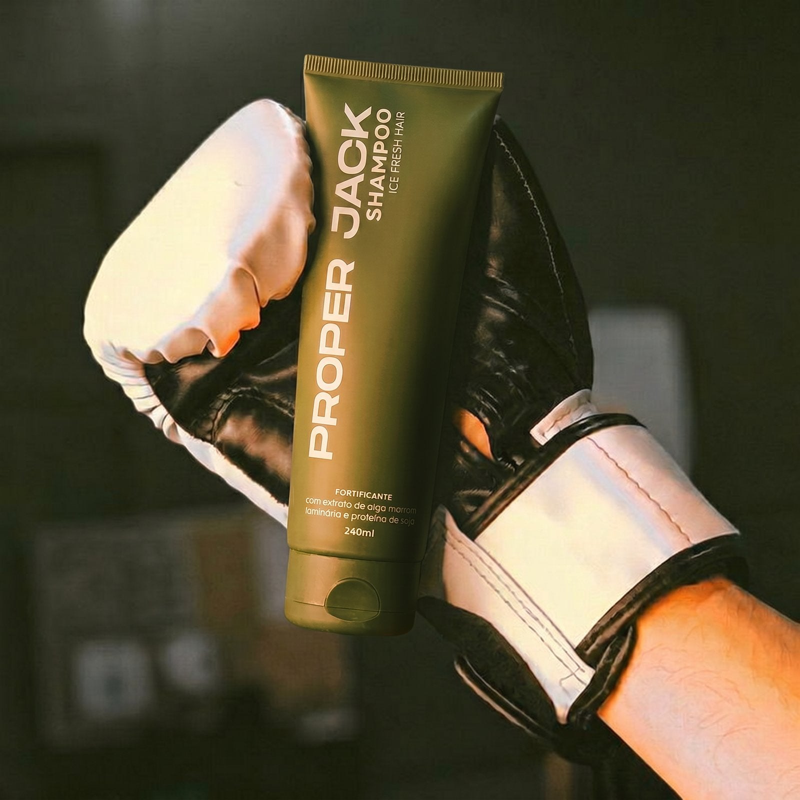 Luvas de boxe segurando o Shampoo Fortificante Proper Jack
